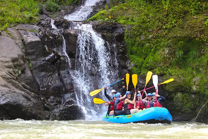 A group of paddlers Pacuare river rafting near a waterfall